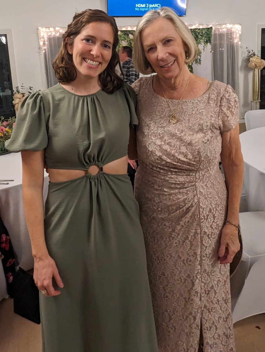 Two women wearing fancy dresses